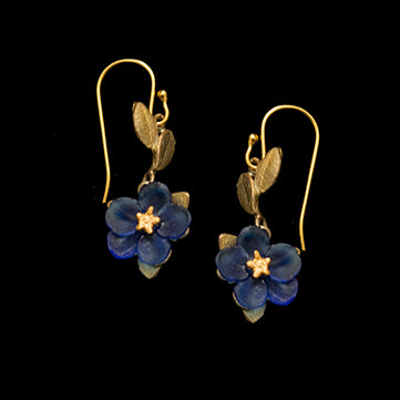 Pair of blue flower earrings with gold accents on a black background