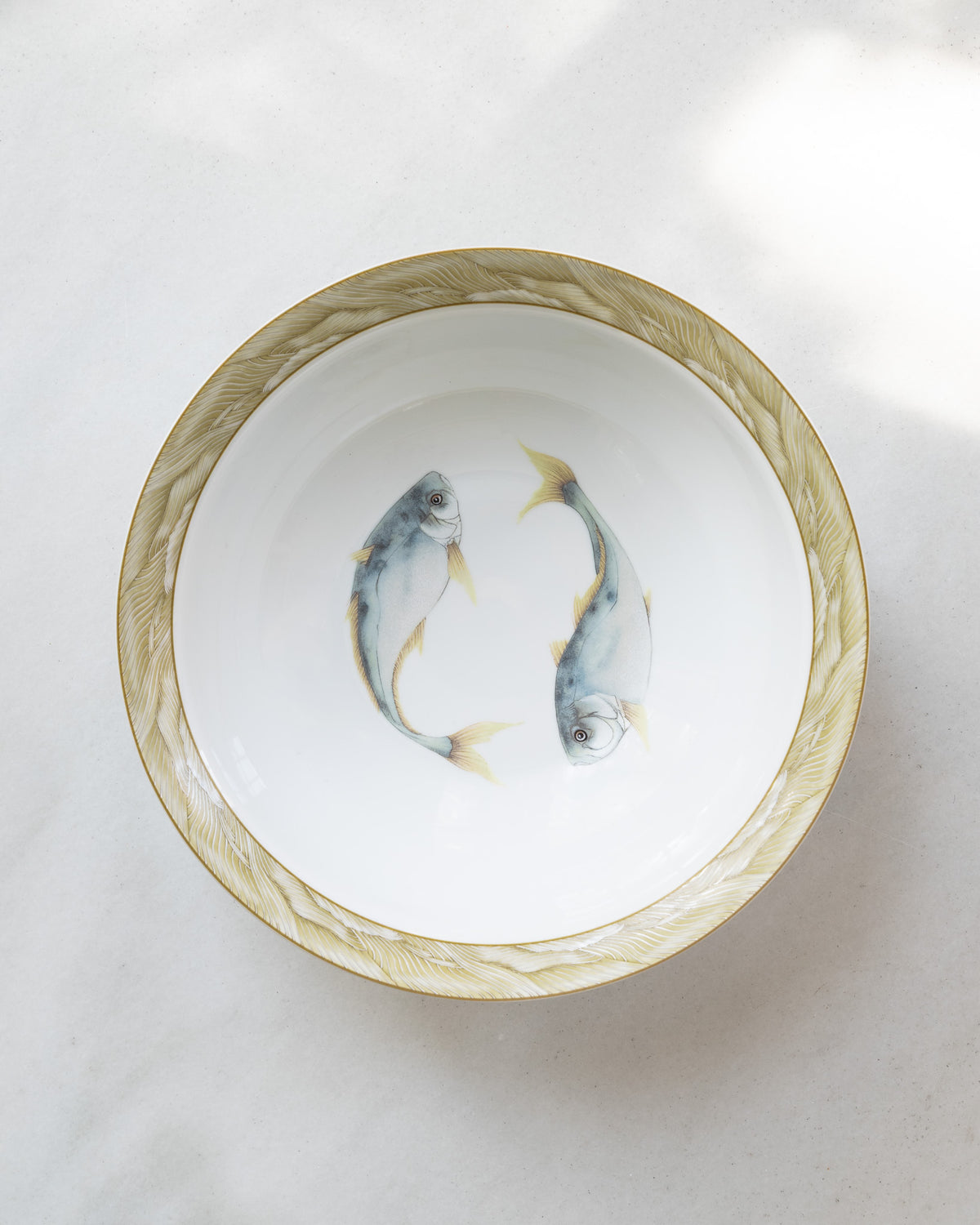 10" white porcelain bowl with olive green rim and a center watercolor motif of two blue trout fish.