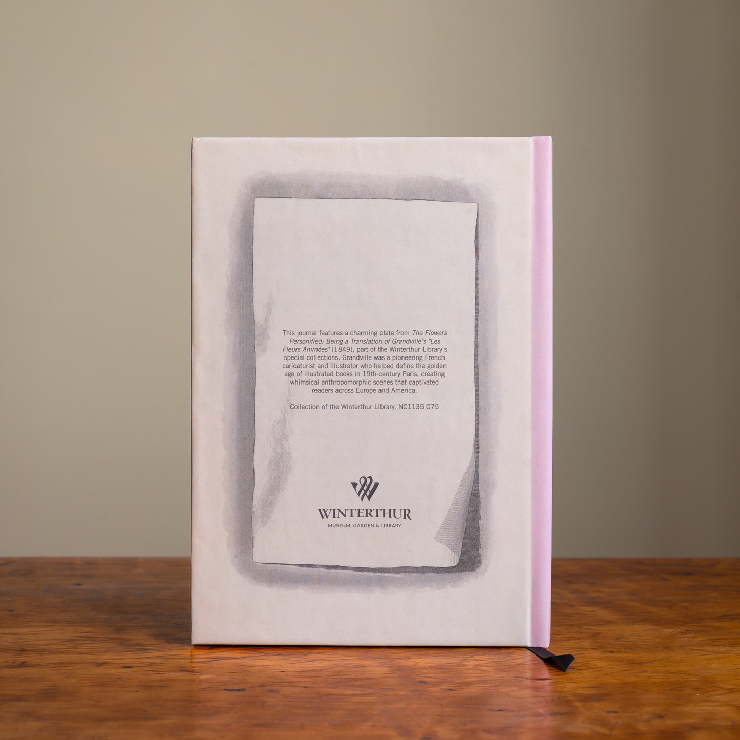 Back cover of a tan notebook with a pink spine, descriptive text, and a gray Winterthur logo.