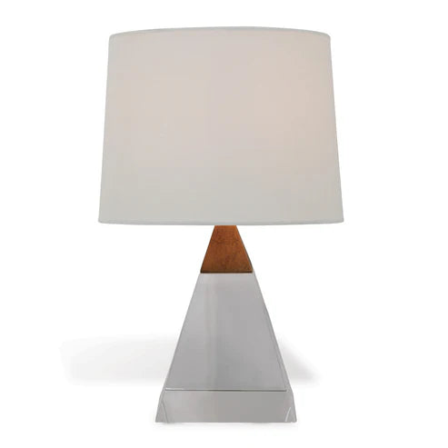 Table lamp with a white shade and a crystal and brass pyramid-shaped base on a white background