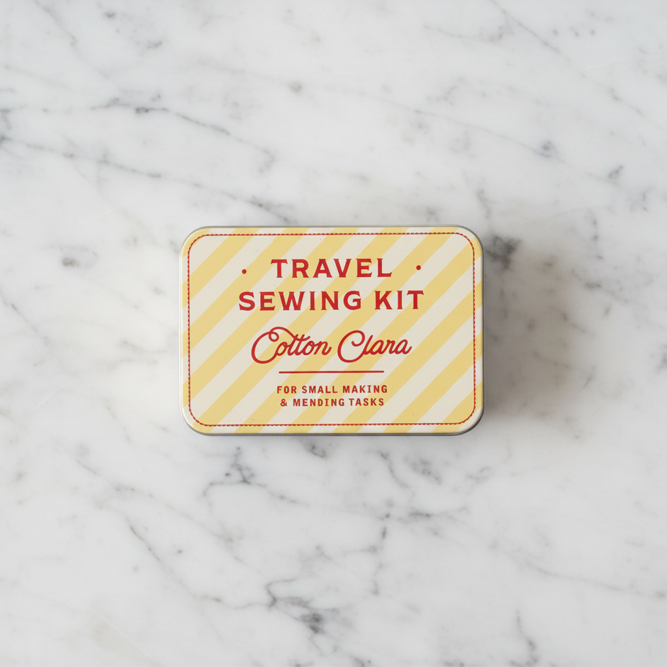 Travel sewing kit with 'Cotton Clara' branding on a white marble tabletop