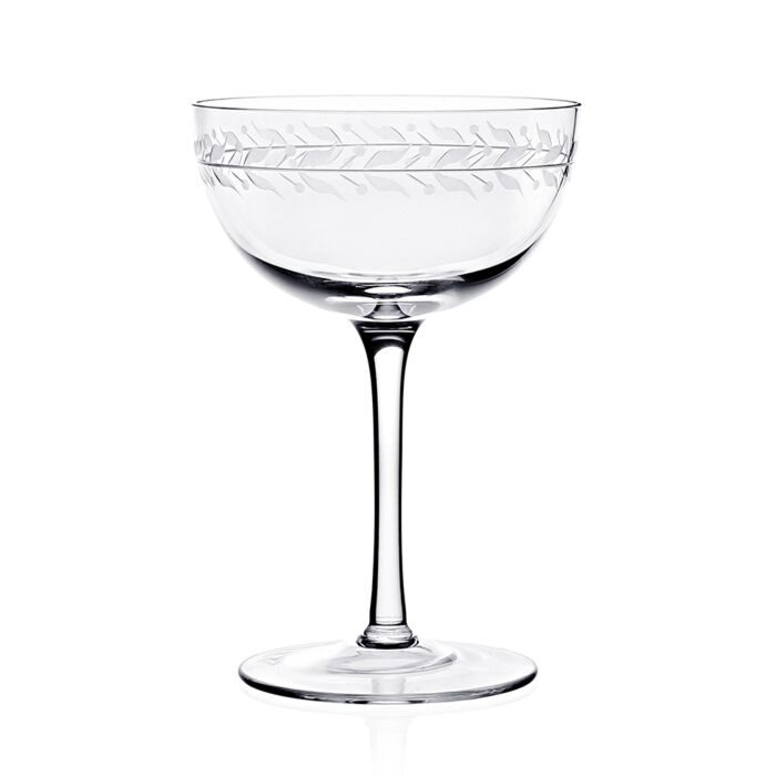 Clear crystal coup glass featuring an engraved vining leaf design around the top rim against a white background.