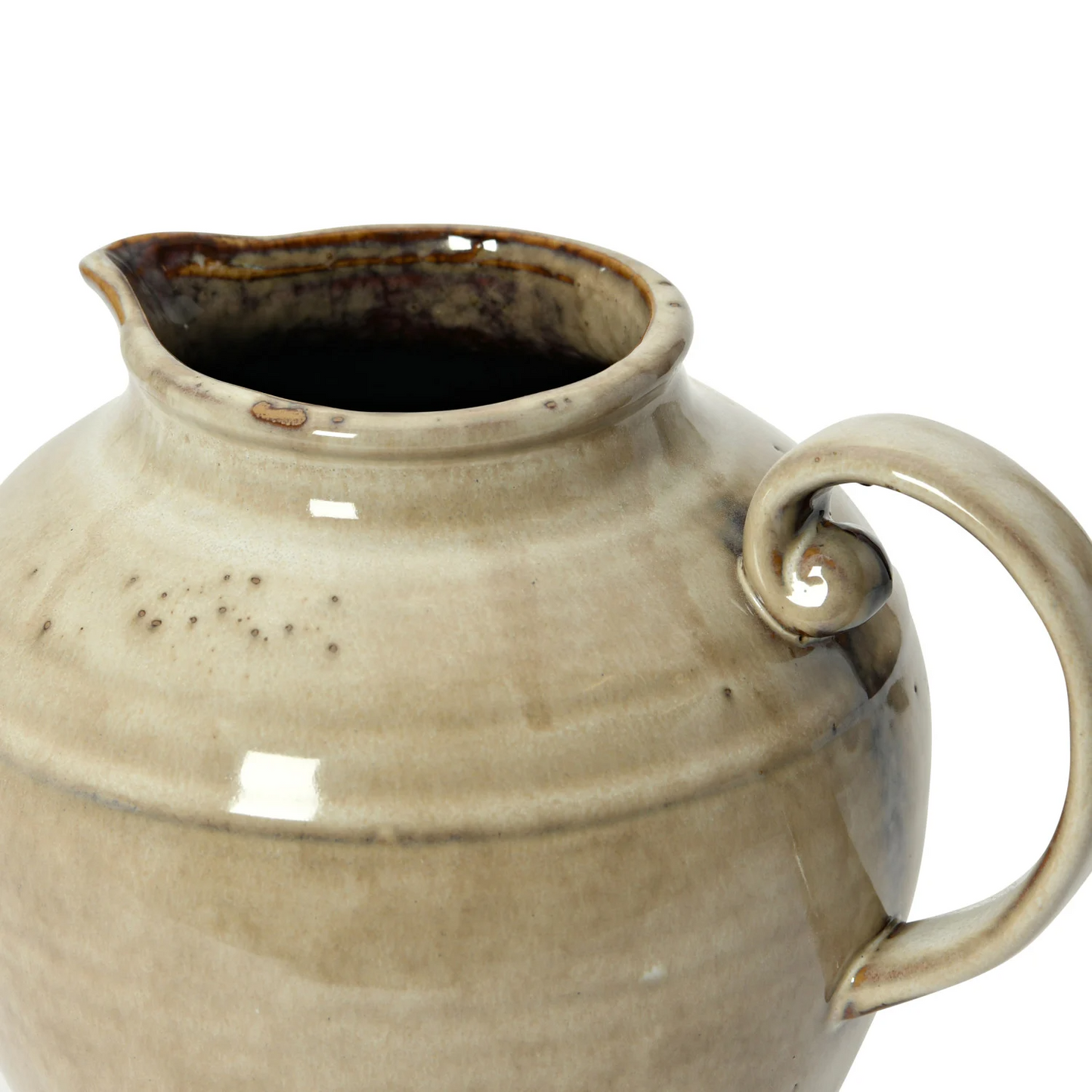 Beige ceramic pitcher with a curved handle on a white background