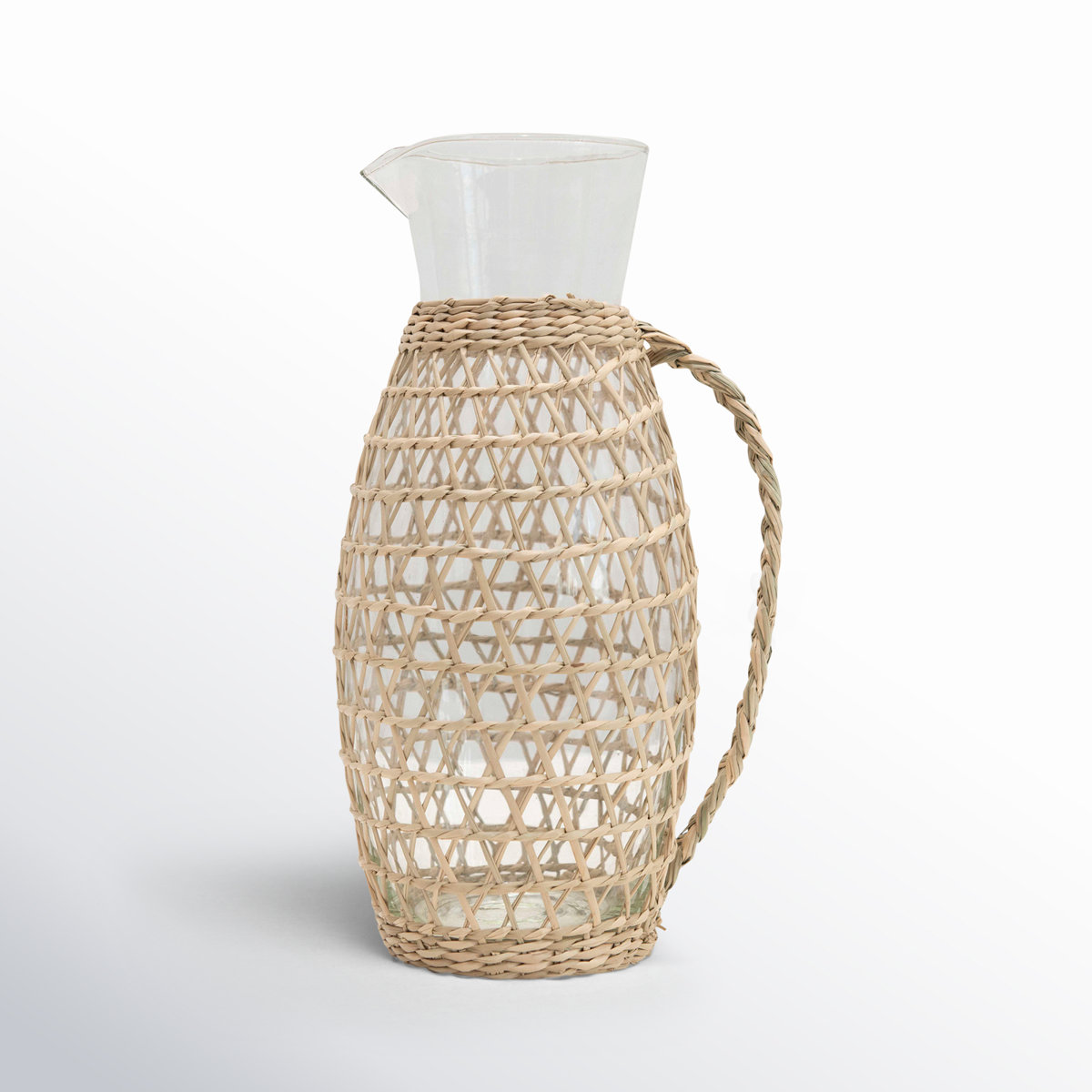 Clear glass pitcher with a natural woven sleeve and handle