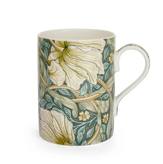 A cylindrical, straight-sided mug featuring a classic curved handle and a floral design in shades of cream, green, and blue on a white background