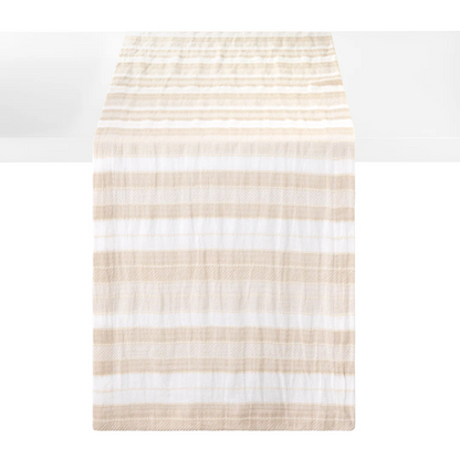 A striped woven cotton table runner with alternating horizontal stripes of beige and white, shown hanging against a white background.