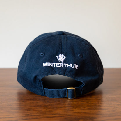 Back of a navy blue baseball hat with the Winterthur logo in white and an adjustable strap with a gold-tone buckle