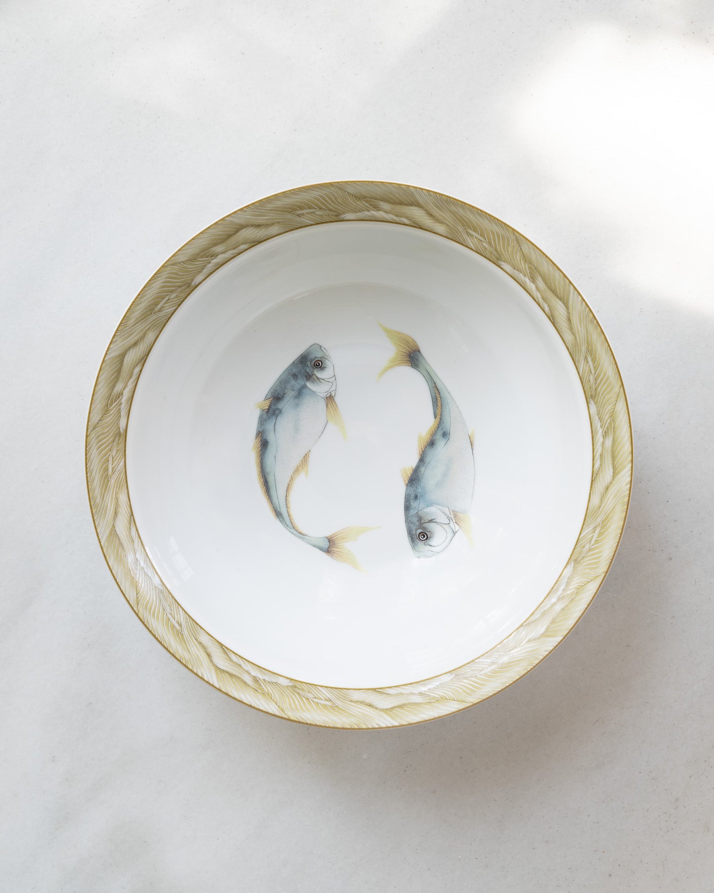 10" white porcelain bowl with olive green rim and a center watercolor motif of two blue trout fish.