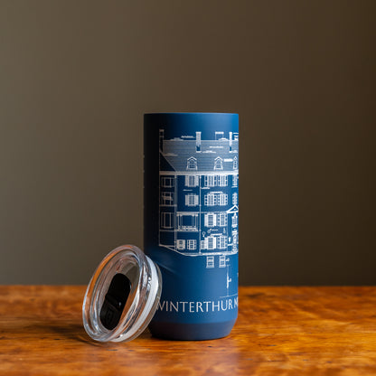 Blue tumbler featuring an architectural sketch and the words "Winterthur Museum, Garden & Library"  under design on a wooden tabletop and dark background