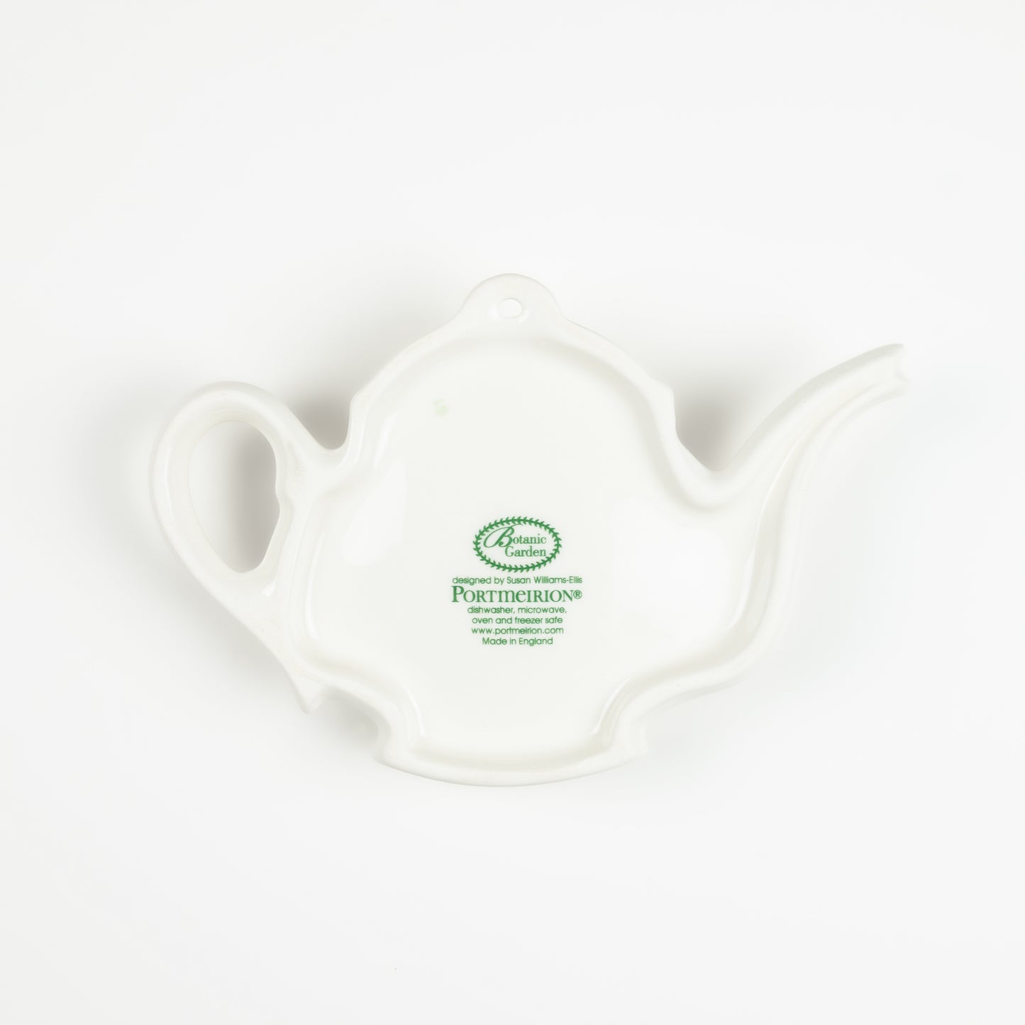 Underside of a white ceramic teapot-shaped spoon rest with a visible brand logo on a white background