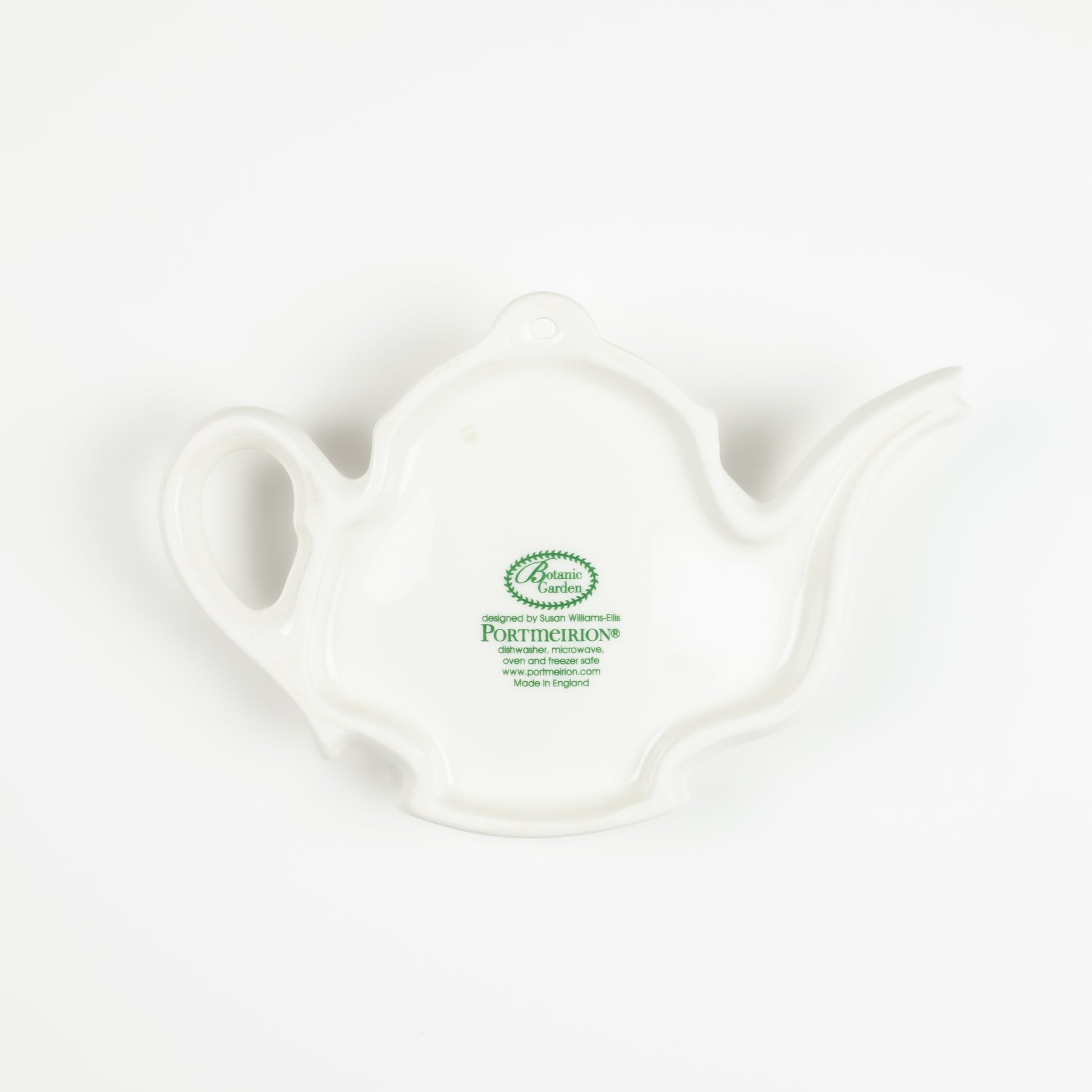 Underside of a white ceramic teapot-shaped spoon rest with a visible brand logo on a white background