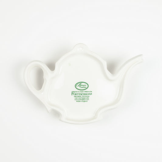 Underside of a white ceramic teapot-shaped spoon rest with a visible brand logo on a white background