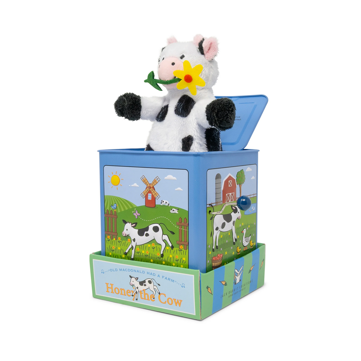 Jack-in-the-box toy with a cow design on a white background