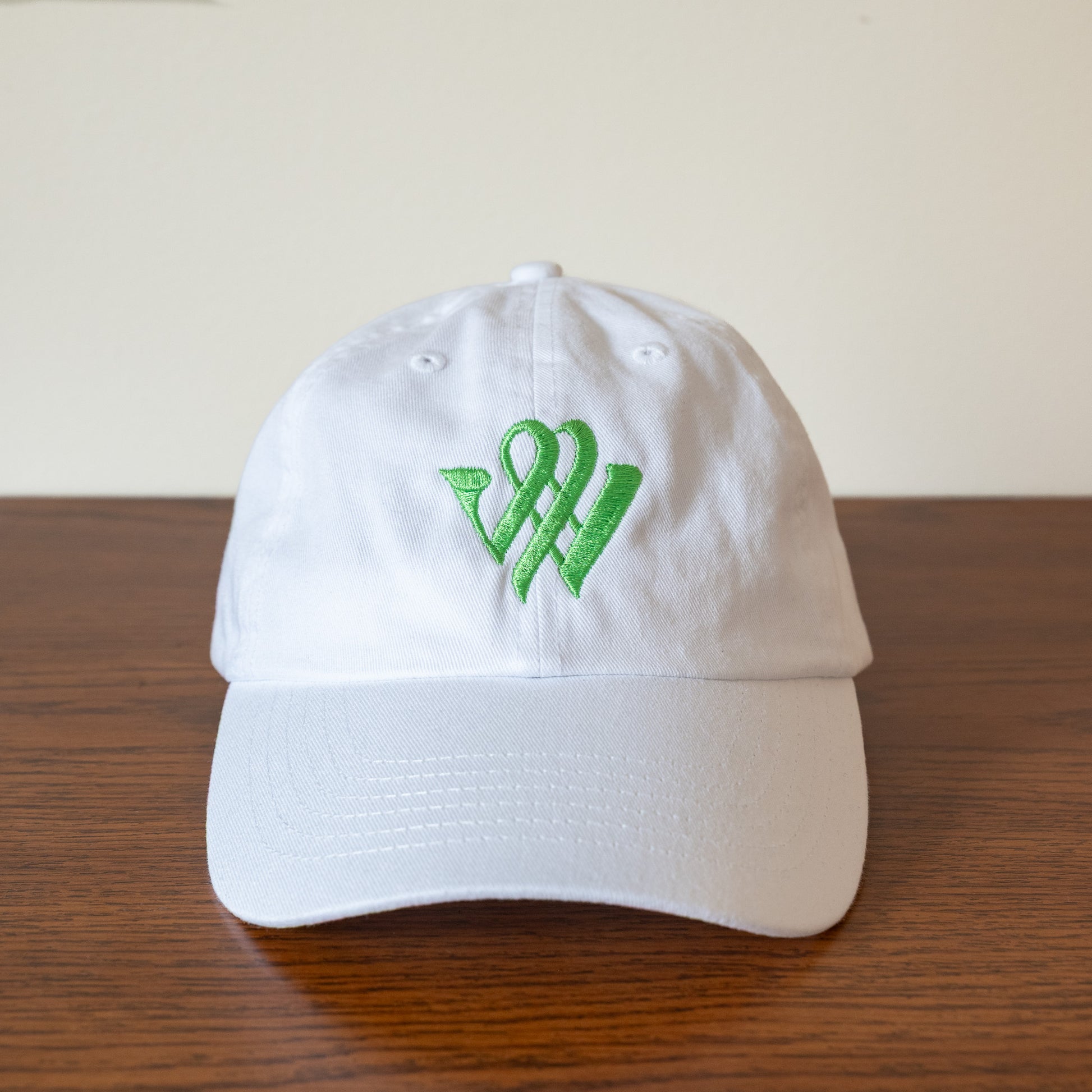 White baseball cap with the Winterthur 'W' logo in green 