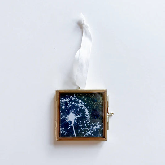 Blue and white allium cyanotype print in a gold frame with a white ribbon