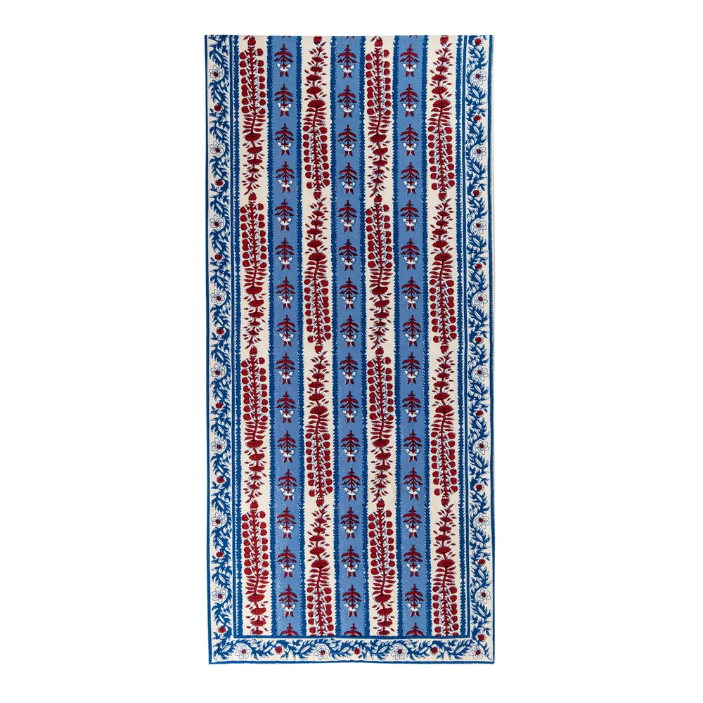 Red, off-white and blue floral block printed table runner against a white background.