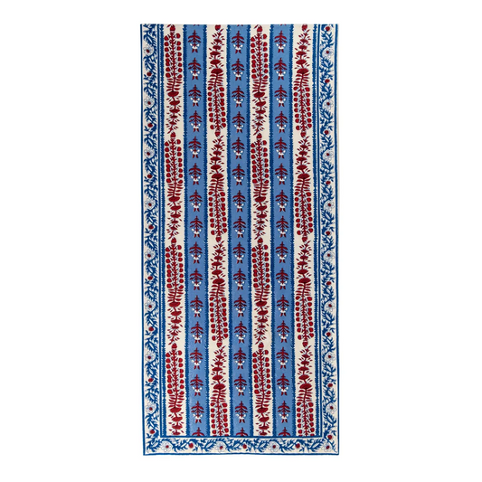 Red, off-white and blue floral block printed table runner against a white background.