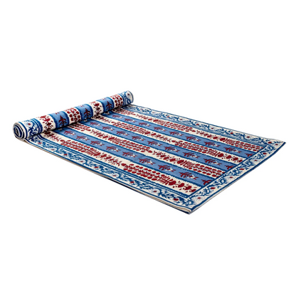 Red, off-white and blue floral block printed table runner against a white background.
