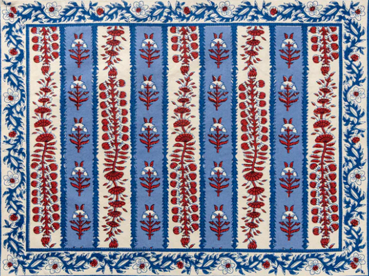 Block printed placemat with red floral patterns on a blue and white striped background