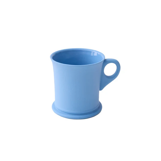 A plain mug in a light blue color, featuring a matte exterior and glazed interior, a circular base and a simple loop handle, shown against a plain white background.