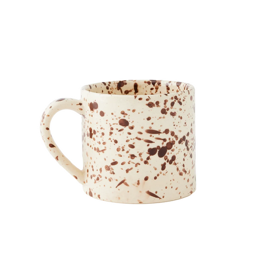 A straight-sided round mug with a warm cream base and translucent brown splattered pattern, shown against a plain white background.