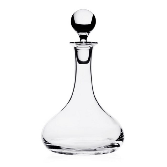 Clear glass decanter with a spherical stopper on a white background