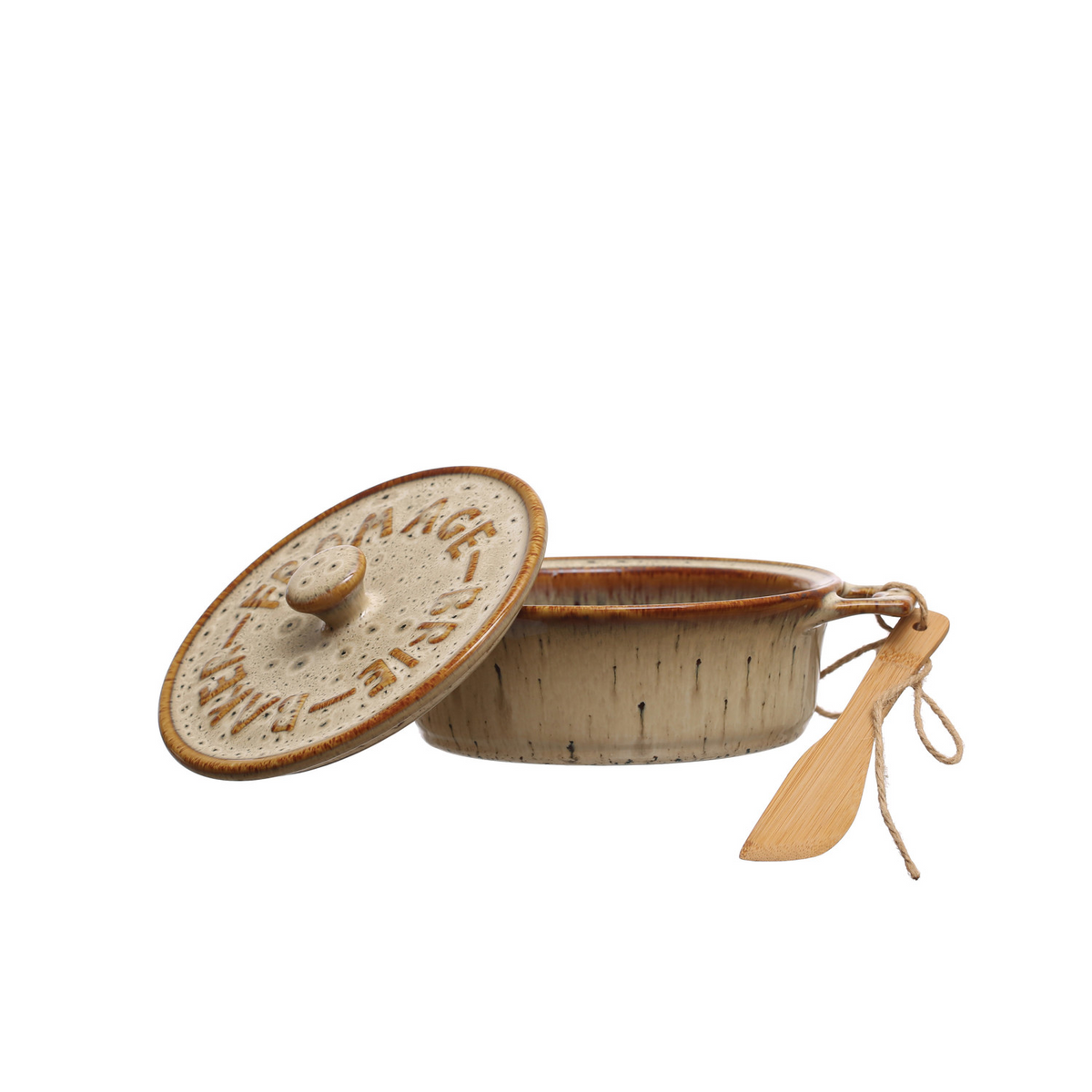 Side view of a beige and brown speckled stoneware baking dish with a wooden spoon tied to one handle with twine and the lid resting on the side. Shown against a white background.