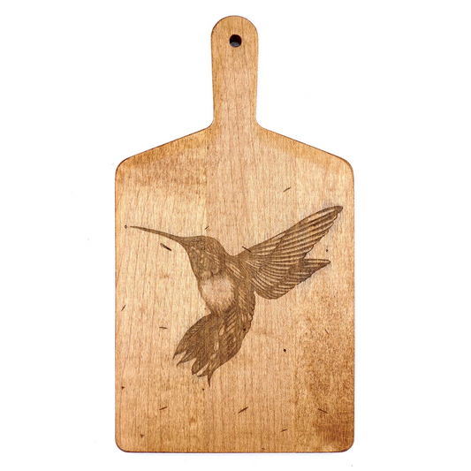 Wooden cutting board with an engraved hummingbird design