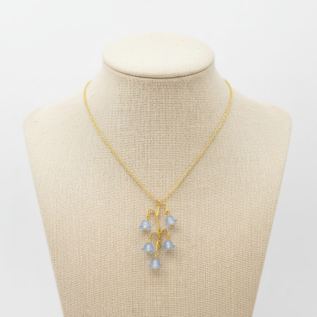 Gold necklace with a five drop lily of the valley pendant