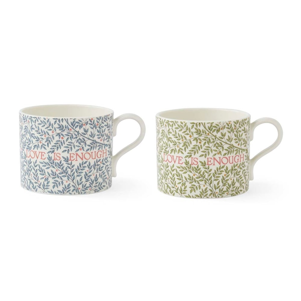 Two patterned ceramic mugs featuring intricate leaf designs, one in blue and one in green, both with the phrase 'LOVE IS ENOUGH' written across the front in red text.