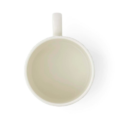 The plain white interior of a ound, straight-sided mug against a white background.