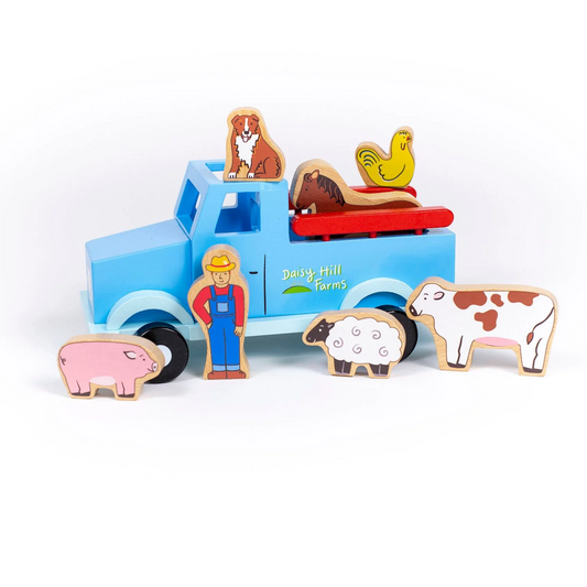 Wooden farmer and farm animal figures with a blue toy truck with the words 'Daisy Hill Farms' on the side 
