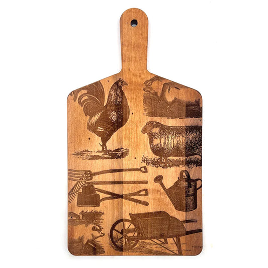 Wooden cutting board with farm-themed designs on a white background