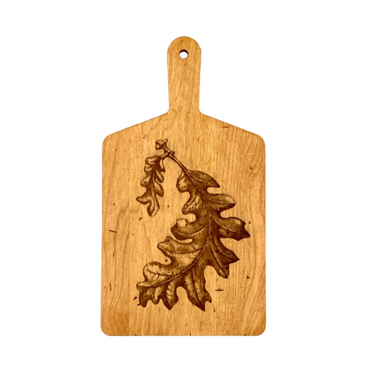 Rectangular wood cutting board with engraved oak leaf design