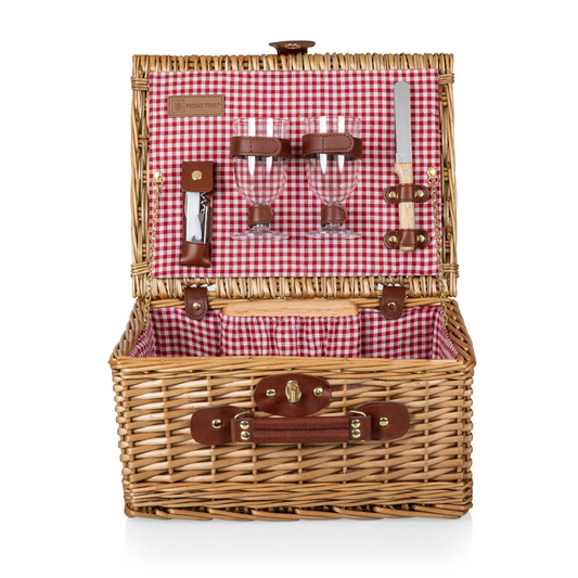 Wicker picnic with a red and white gingham interior and brown leather trim. Set includes two wine cups, wine bottle opener, cheese board, and cheese knife.