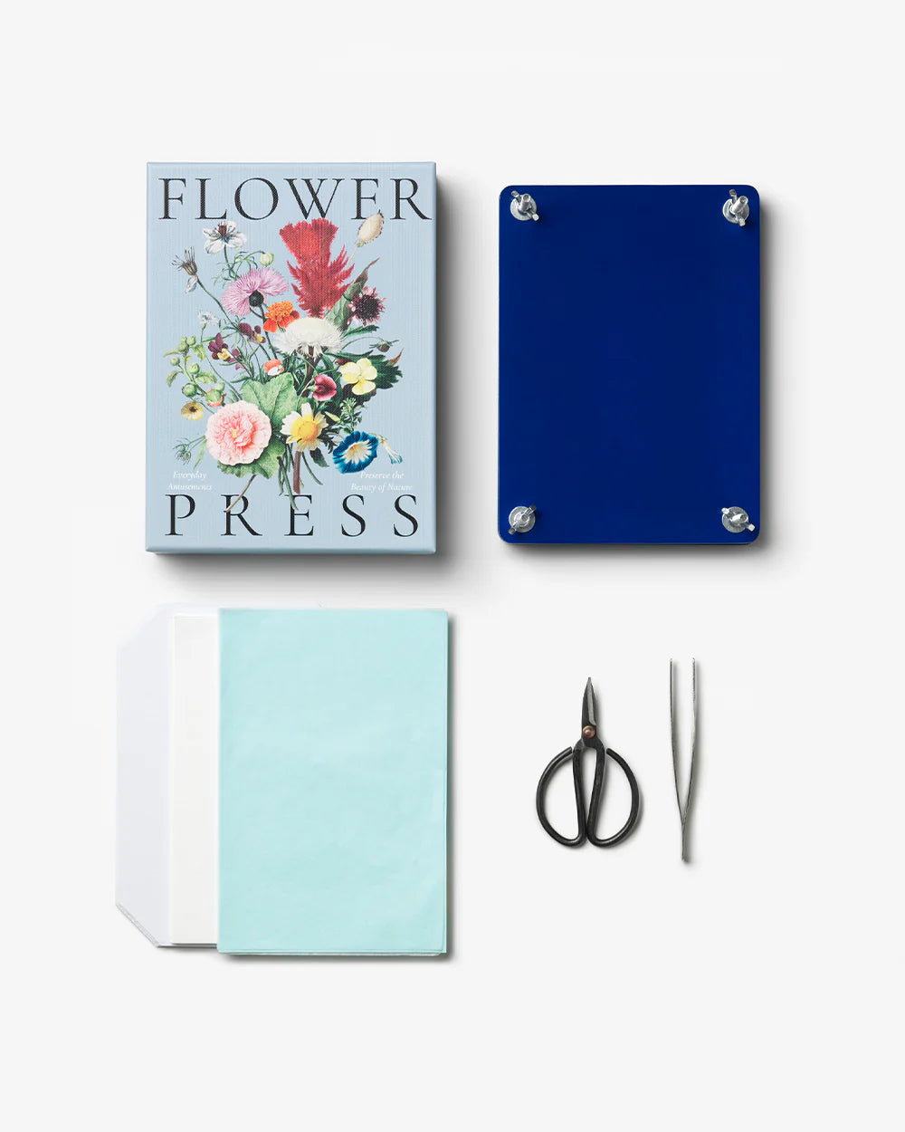 Floral Press kit box and contents, including two blue wooden press plates with cardboard spacers, stainless steel scissors and tweezers, water-absorbing paper and art paper