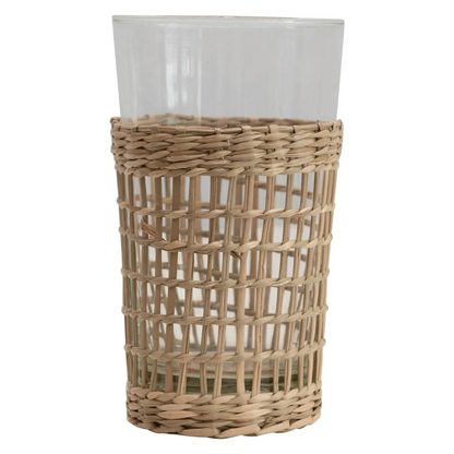 Clear glass drinking cup with a woven seagrass sleeve