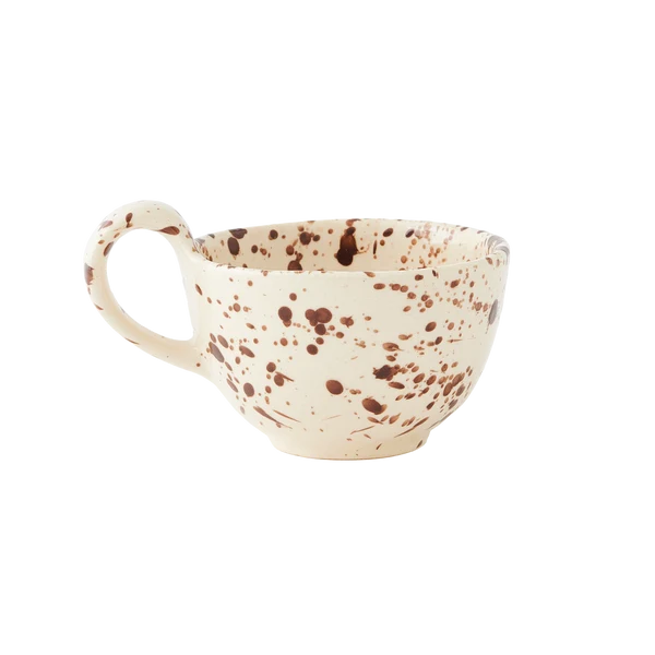 A short tapered round teacup featuring a curved handle with a warm cream base and translucent brown splattered pattern, shown against a plain white background.