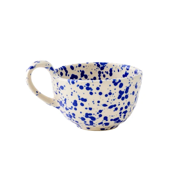 A short tapered round teacup featuring a curved handle with a warm cream base and translucent cobalt blue splattered pattern, shown against a plain white background.
