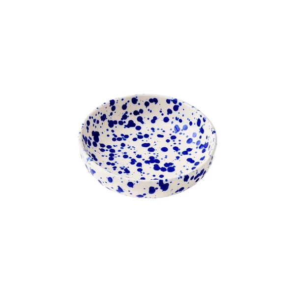 A small round ceramic bowl with a cream-colored base decorated with a translucent cobalt blue splattered pattern on a white background