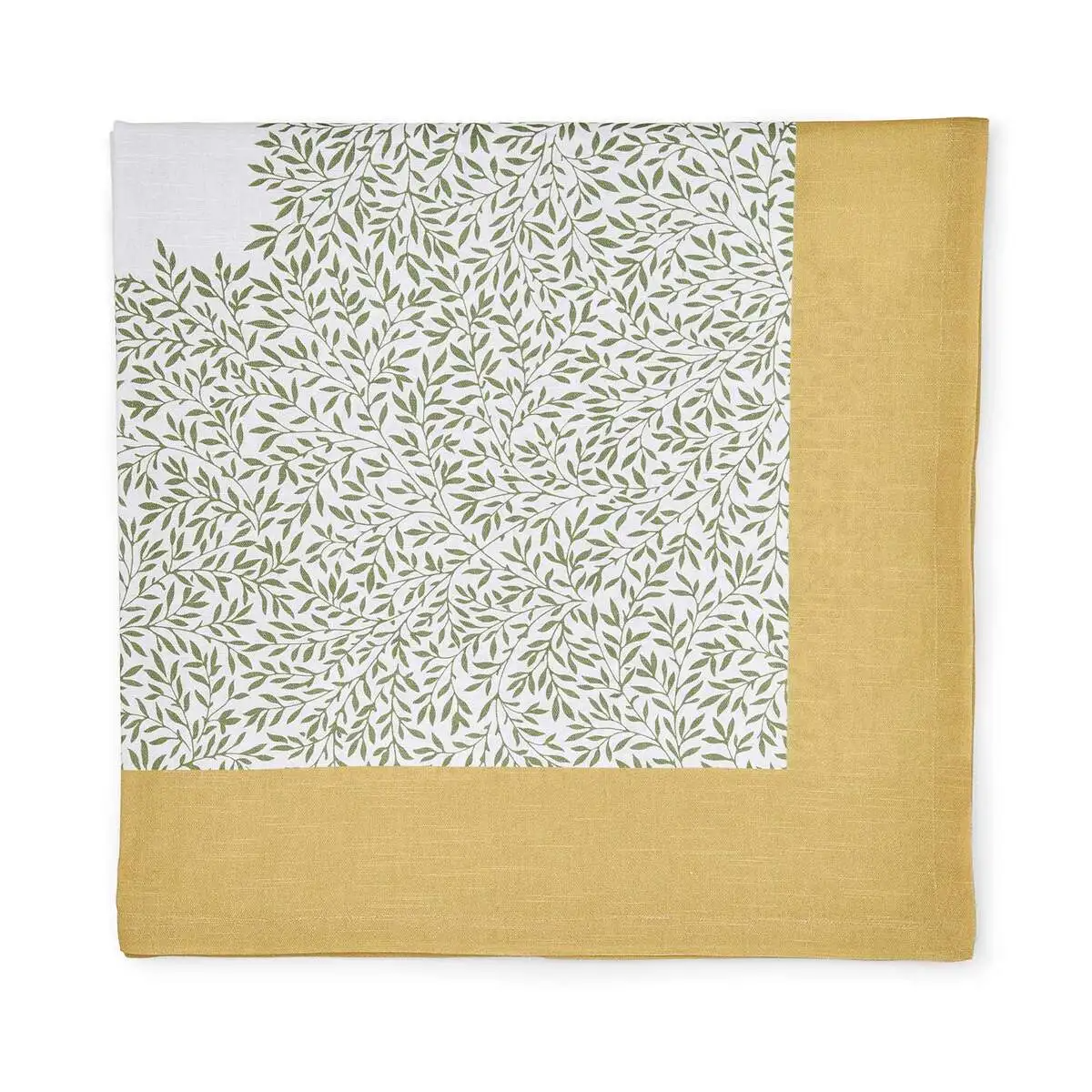 Corner detail of a folded cotton tablecloth featuring a green leaf pattern on off-white and a yellow border.