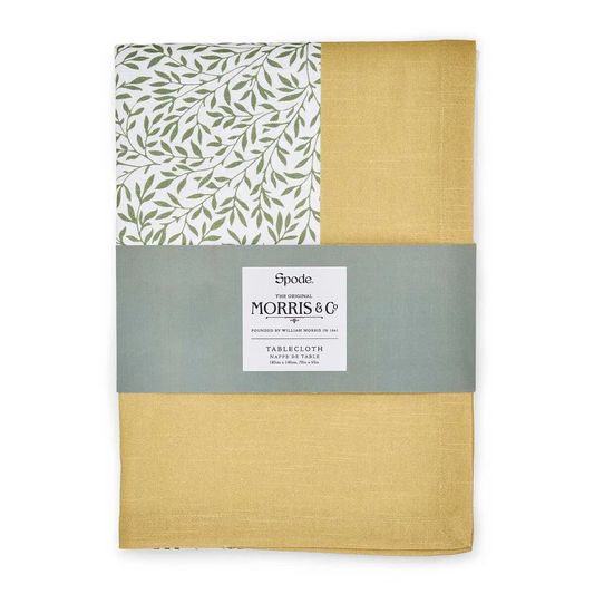 A packaged tablecloth featuring a green leaf pattern on off-white and a yellow border, wrapped in a band labeled "Spode The Original Morris & Co Tablecloth."