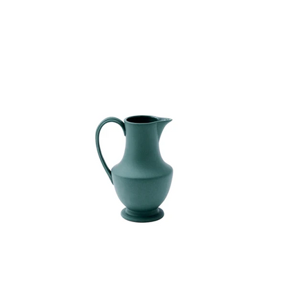 A matte deep teal ceramic pitcher with a curved handle and spout, centered on a plain white background.