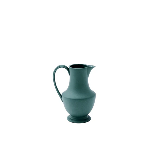 A matte deep teal ceramic pitcher with a curved handle and spout, centered on a plain white background.