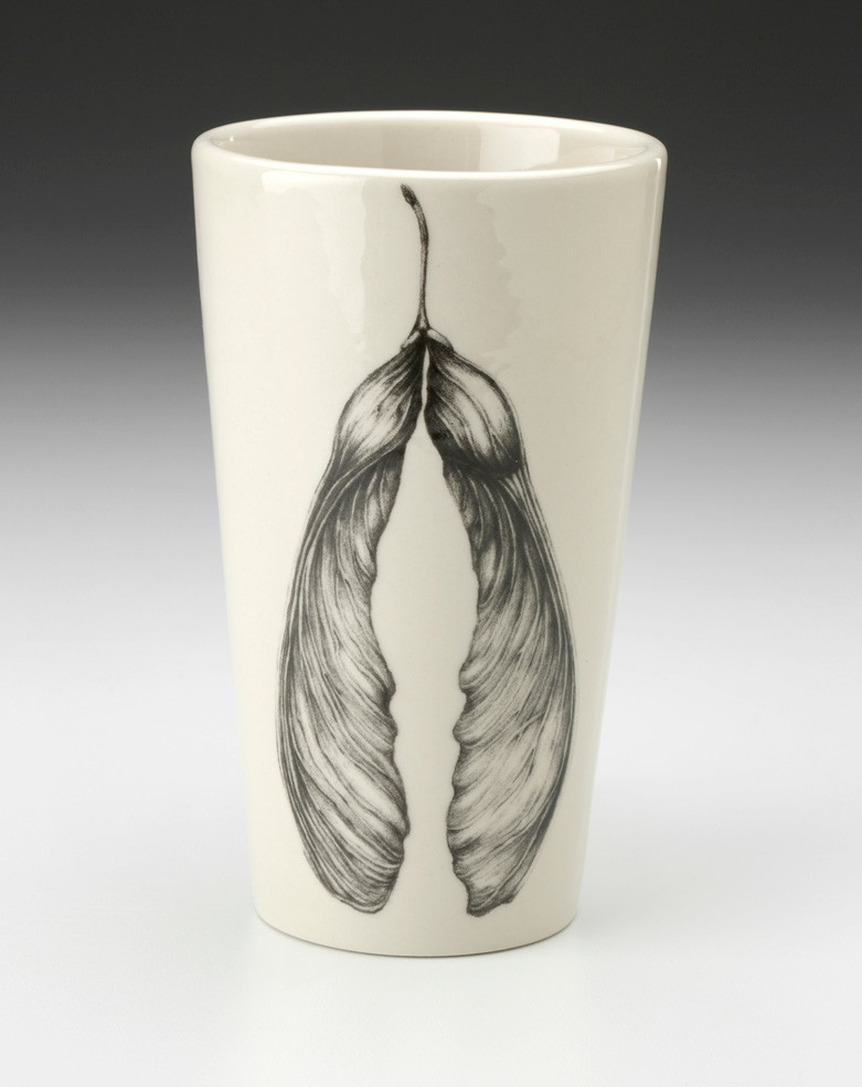 An off-white stoneware tapered travel mug featuring a sketch of two connected maple seeds in black.