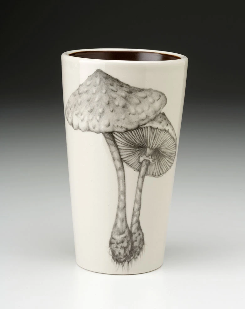 An off-white stoneware tapered travel mug featuring a sketch of two mushrooms in black.