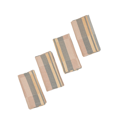 Four rectangular woven fabric napkins with vertical stripes in off-white, yellow, gray, and muted orange, arranged diagonally on a plain white background.