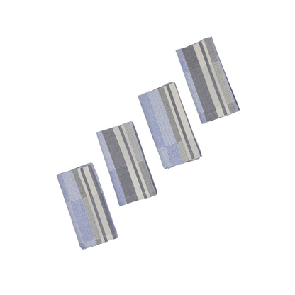 Four rectangular woven fabric napkins with vertical stripes in off-white, gray, navy, and cobalt blue, arranged diagonally on a plain white background.