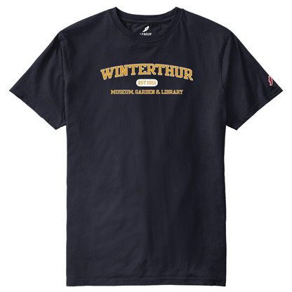 Navy blue crewneck, shirtsleeve t-shirt with the words 'WINTERTHUR EST 1951 MUSEUM, GARDEN & LIBRARY' screen-printed in gold and white across the chest 