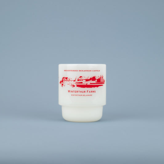 A white milk glass mug with the words 'REGISTERED HOLSTEIN CATTLE' in red above a red barn graphic with "WINTERTHUR FARMS - WINTERTHUR, DELAWARE' in red below against a blue background